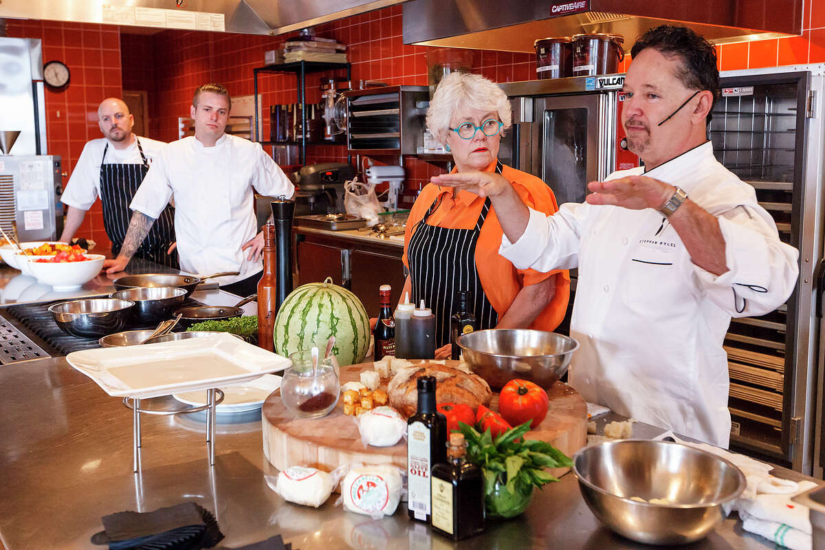 Celebrity Chef Stephan Pyles (from right) and Paula Lambert, founder of Dallas' Mozzarella Company, prepare a Tomato, Watermelon and Mozzarella Salad for an audience during a cooking demonstration at Sustenio at The Éilan Hotel & Spa during "Ripe: A Spirited Market at Éilan" on Sunday, July 21, 2013. Twenty-seven vendors including food trucks participated in the event. The market will run monthly through August and weekly on Sundays starting September 8. MARVIN PFEIFFER/ mpfeiffer@express-news.net