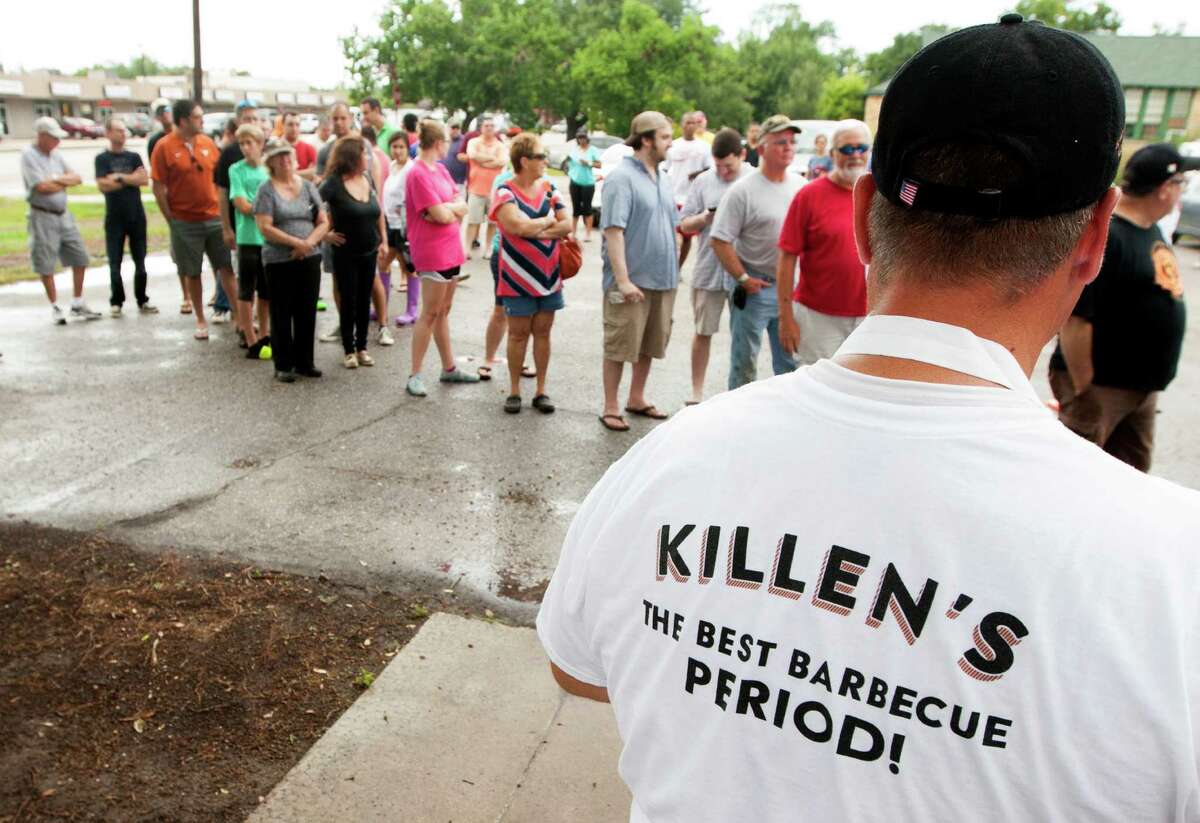Customers line up outside on Saturday, Aug. 10, 2013, in Pearland. Ronnie Killen, known to all for his steakhouse is now readying an old school cafeteria in Pearland to be the new home of Killen's Barbecue. ( J. Patric Schneider / For the Chronicle )