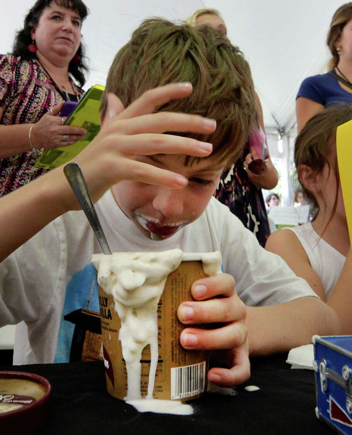 Andrew Desso, 9, of Painted Post has a little brain freeze while devouring a pint of Stewart's Philly Vanilla ice cream during the annual Stewart's ice cream eating contest Wednesday, Aug 19, 2013, at the Saratoga Race Course in Saratoga Springs, N.Y. The contest is held annually during Travers Stakes week at the Spa. (Skip Dickstein/Times Union)
