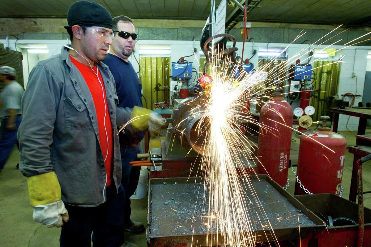 Jason Ducey, right, works with a fellow student at a pipe fitters training facility Wednesday, Aug. 21, 2013, in Houston. With the expanding production in North America, more trained workers are going to be needed. ( Brett Coomer / Houston Chronicle )