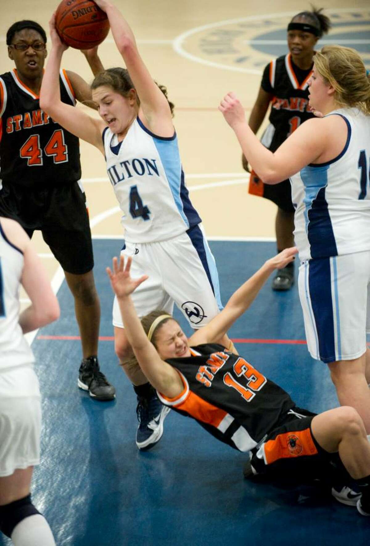 Wilton's Casey Pearsall, left, and Stamford's Kelsey Cognetta tangle over a rebound during an FCIAC girls basketball game at Wilton High School in Wilton, Conn. on Thursday, Jan. 21, 2010.
