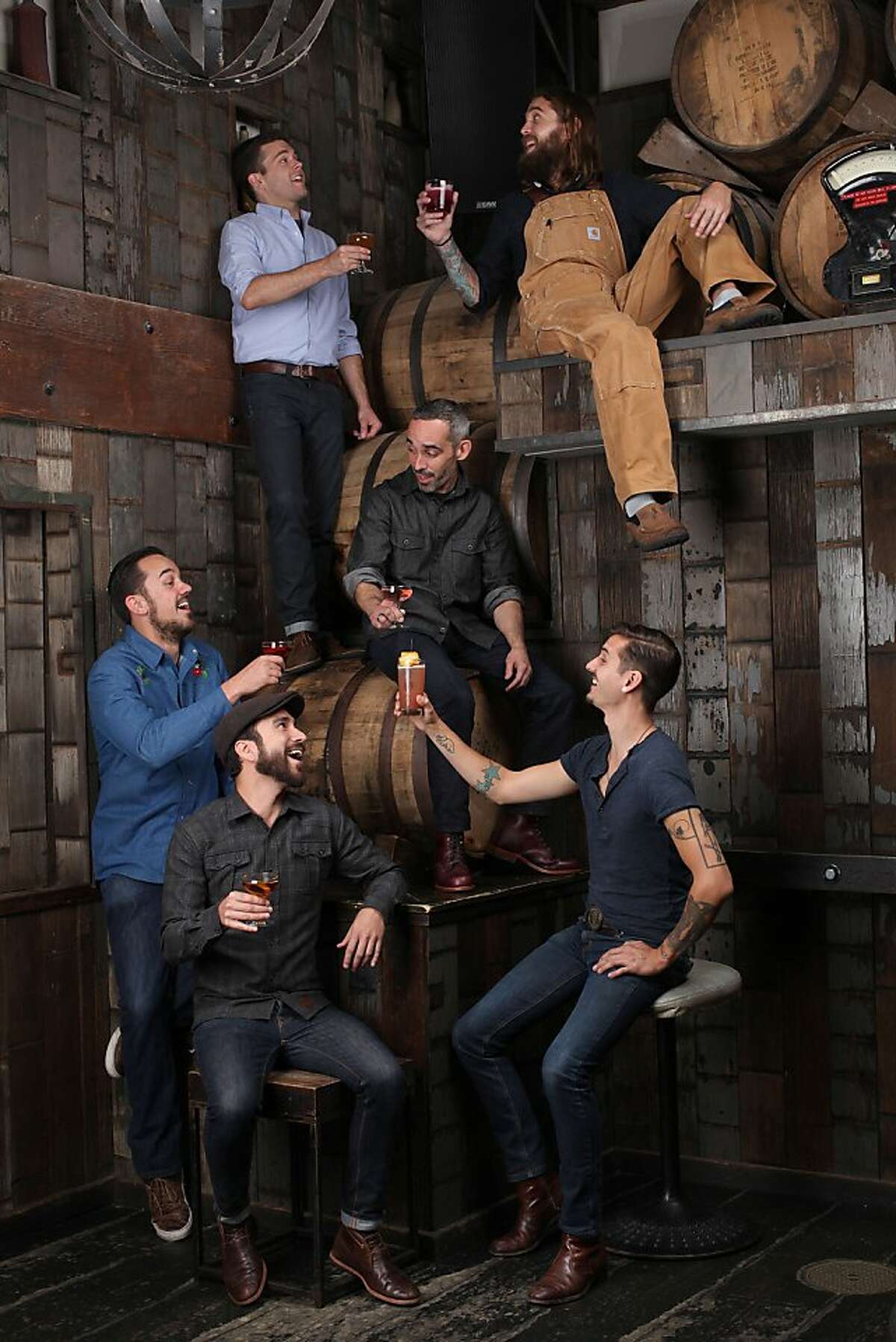 Clockwise from top left--Bartenders Michael Lay, Matthew Campbell (tan overalls), Chris Lane (lower right), Dan Stahl (seated left), Lucien Sankey, and Matty Conway (middle seated on barrel) photographed at Rickhouse in San Francisco, Calif., on Tuesday, August 13, 2013.