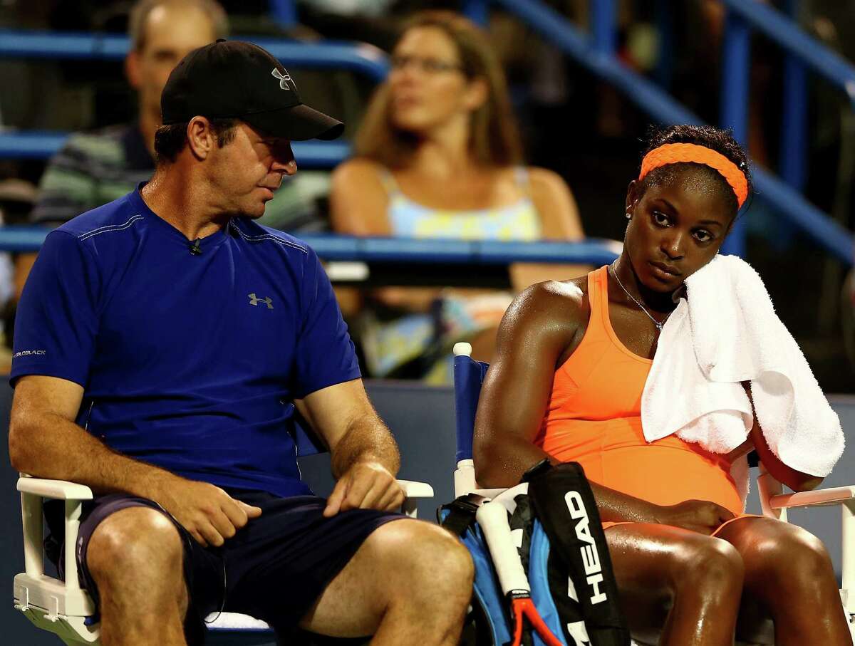 NEW HAVEN, CT - AUGUST 22: Sloane Stephens of the USA talks with her coach, David Nainkin, after she lost the first set to Caroline Wozniacki of Denmark during Day Five of the New Haven Open at Connecticut Tennis Center at Yale on August 22, 2013 in New Haven, Connecticut.