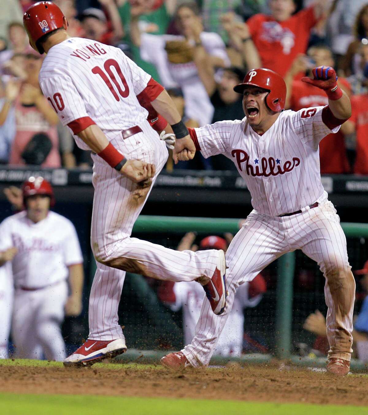 Despite their team being all but out of the playoff picture, Michael Young, left, and Carlos Ruiz had plenty to celebrate after the Phillies' walkoff win.