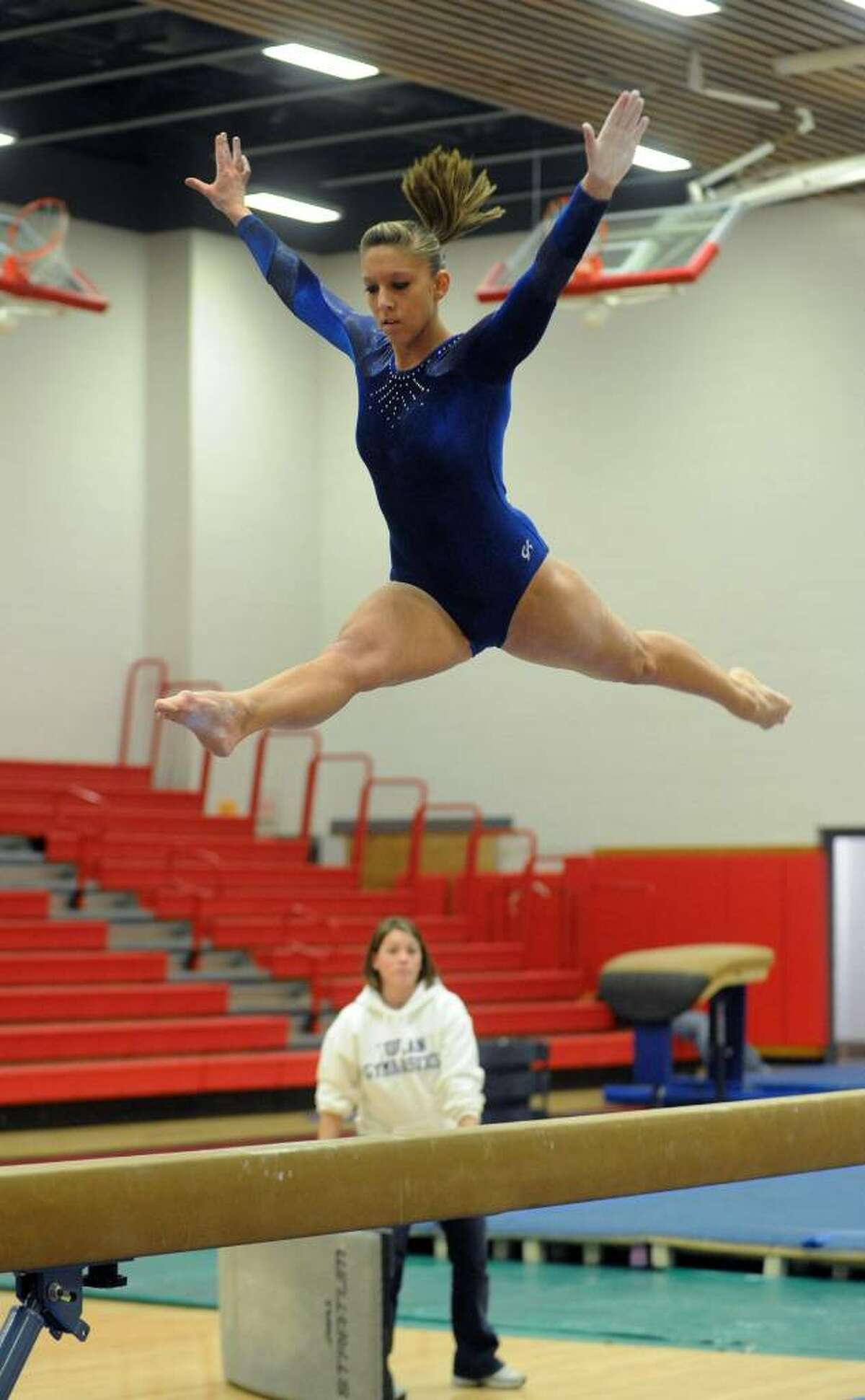 Foran's Andrea Figuly performs a leap on the balance beam, during gymnastics action against Jonathan Law in Milford, Conn. on Thursday Jan. 21, 2009.