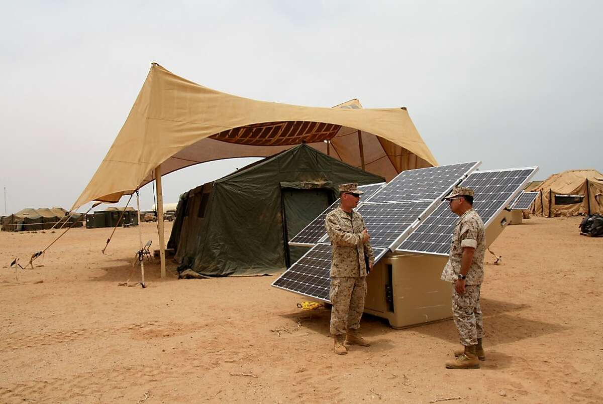 CAPTION: "Maj. Sean M. Sadlier (left) of the U.S. Marine Corps Expeditionary Energy Office explains the solar power element of the Expeditionary Forward Operating Base concept to Col. Anthony Fernandez during the testing phase of this sustainable energy initiative here, May 19. The ExFOB is designed primarily for use by small Marine Corps units at forward operating bases in Afghanistan. Fernandez, a Marine Corps Reservist with a combined 28 years in the Corps, is the African Lion 2010 task force commander here." DATE: May 21, 2010 BY: U.S. Marine Forces Africa LOCATION: The African Lion operation, where this comes from, was based in Morocco