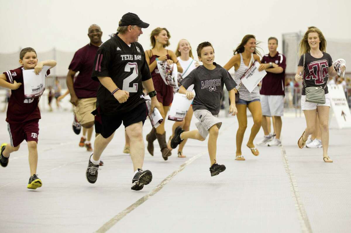 The race is on as Texas A&M fans run to get in line to get an autograph from quarterback Johnny Manziel on Saturday.