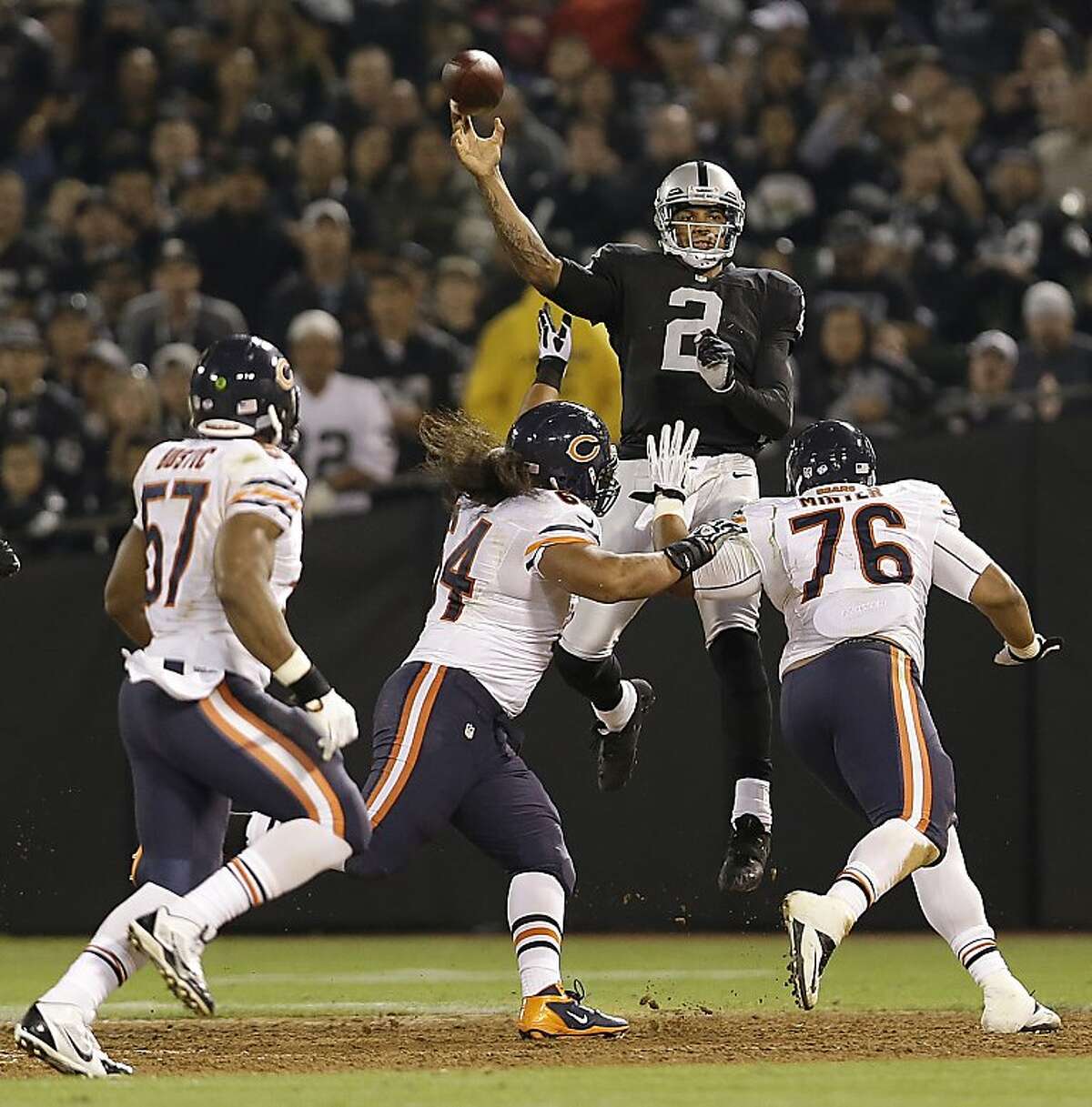 Oakland Raiders quarterback Terrelle Pryor (2) throws as Chicago Bears inside linebacker Jon Bostic (57), defensive tackle Christian Tupou (64), and defensive tackle Zach Minter (76) apply pressure during the third quarter of an NFL preseason football game in Oakland, Calif., Friday, Aug. 23, 2013. (AP Photo/Marcio Jose Sanchez)