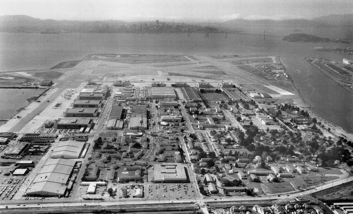 Aerial view of Alameda Naval Air Station. The Bay Bridge and the S.F. skyline are visible in the background. March 11, 1993.