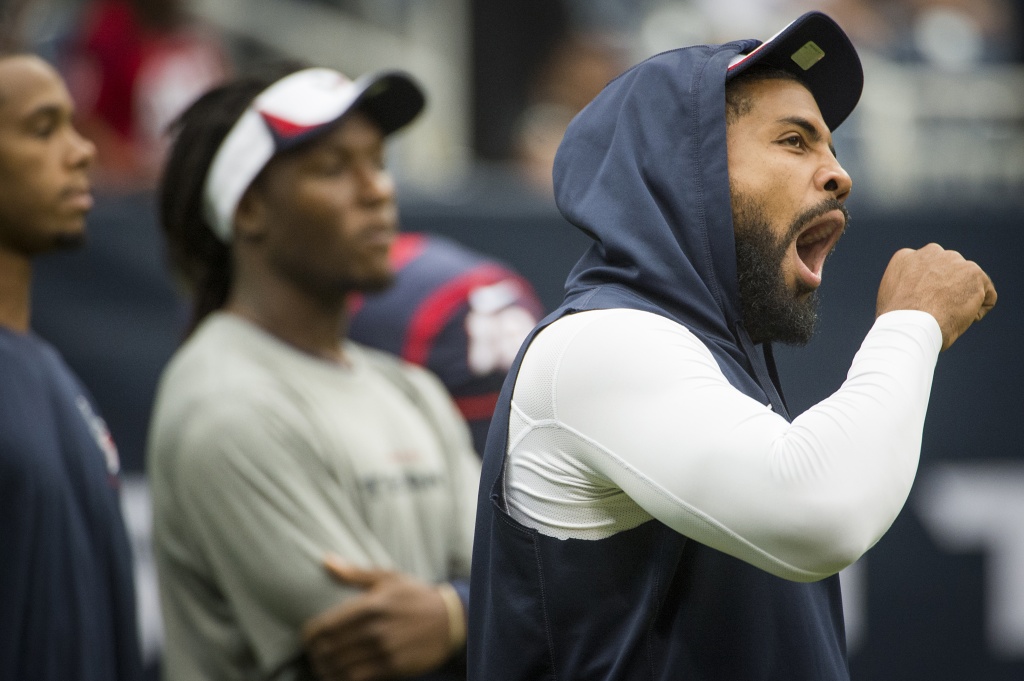 Denver Broncos defensive end Jeremy Mincey (57) wipes his face as