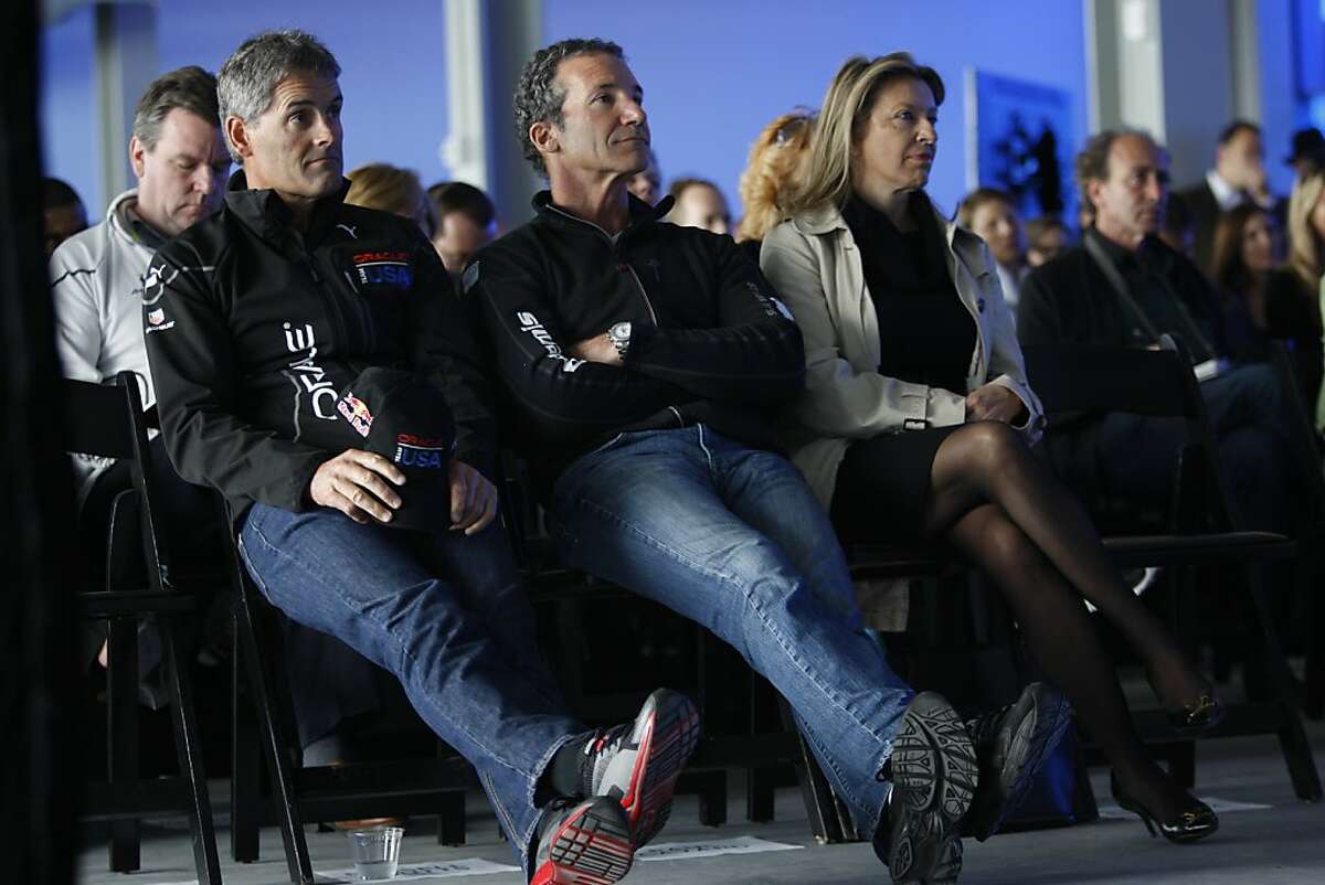 Team Oracle's own helmsman Russell Coutts (left) and five-time America's Cup veteran Paul Cayard (middle) listen to a press conference about this year's America Cup at Pier 27 in San Francisco, California, on Wednesday, April 3, 2013.