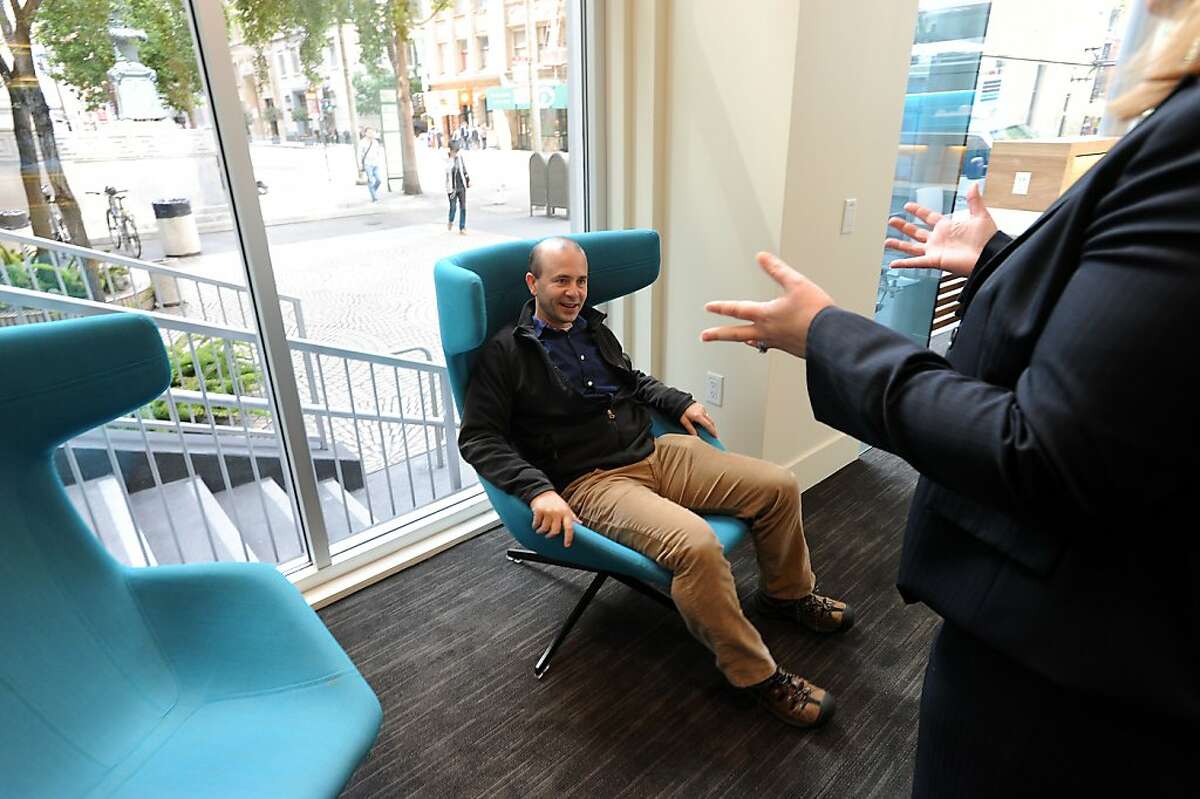 Guest Jon Ford tires out one of the lounge chairs in the resource center during the grand opening of Umpqua Bank's flagship store in San Francisco, California on Monday, August 26, 2013.