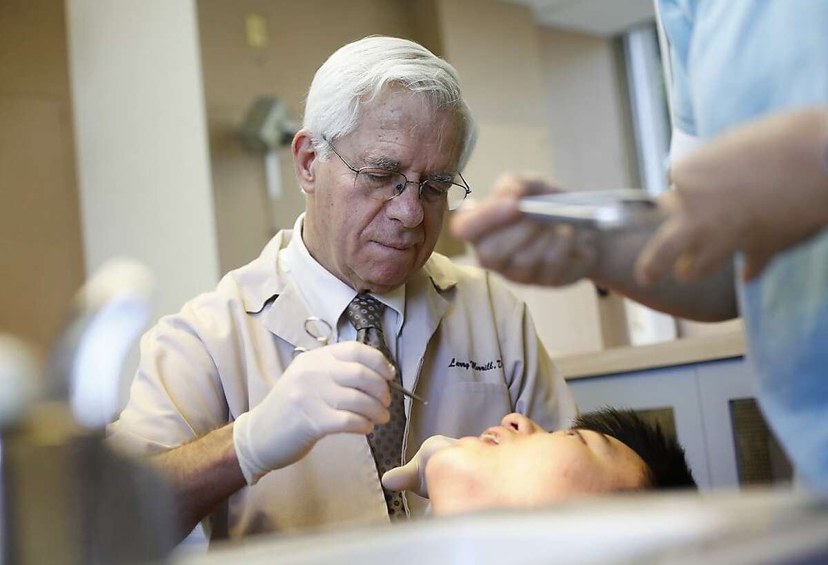 Larry Morrill, an orthodontist, works at his office in Palo Alto, Calif., Thursday, August 22, 2013. Morrill is also patient with osteoarthritis who was helped by a clinical trial at the new arthritis center opened by Stanford-UCSF.