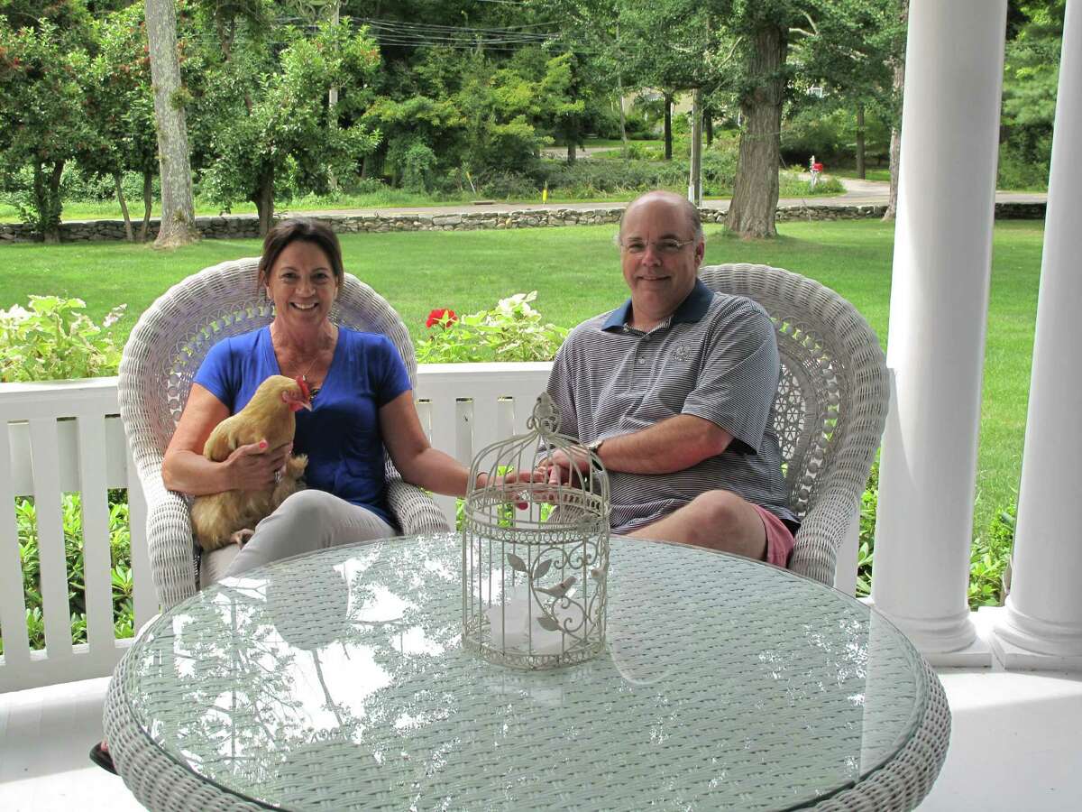 Debbie and Kevin McQuilkin sit on their porch at 757 Oenoke Ridge. The couple bought the house, which was built in 1886, two years ago. Aug. 23, 2013, New Canaan, Conn.