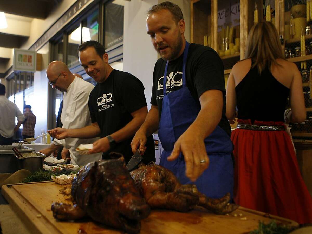 Chef Ryan Farr from '4505 Meats' prepares dishes using a whole roasted pork during the Center for Urban Education about Sustainable Agriculture (CUESA) summer celebration in San Francisco, Calif., on July 11, 2011.
