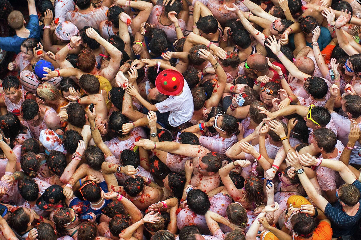 Revelers throw tomatoes while participating the annual Tomatina festival on August 28, 2013 in Bunol, Spain. An estimated 20,000 people threw 130 tons of ripe tomatoes in the world's biggest tomato fight held annually in this Spanish Mediterranean town.