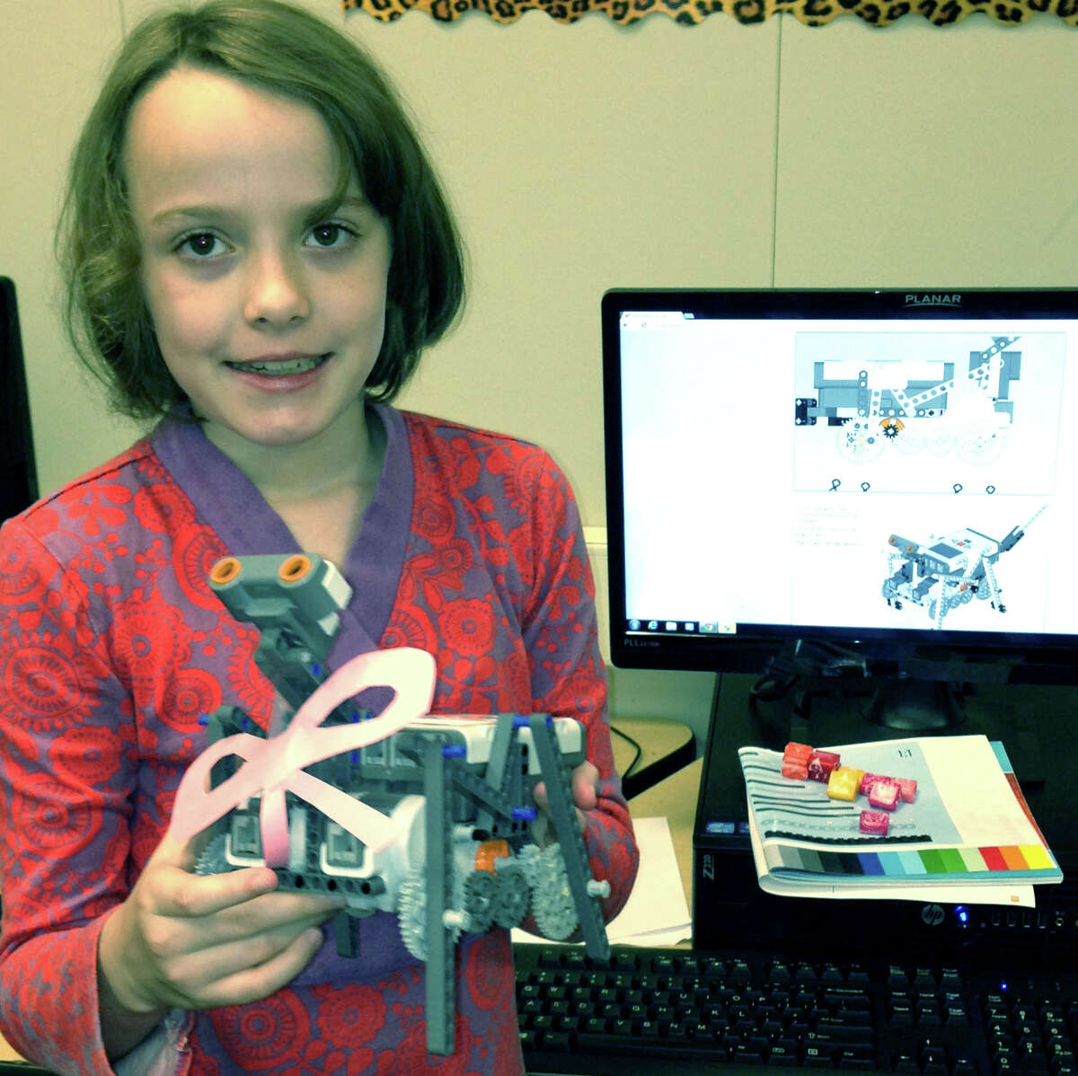 Madeline Martin shows off the robot she built during her experience in the Shepaug summer enrichment program. July 2013 Courtesy of Sheila Gambino