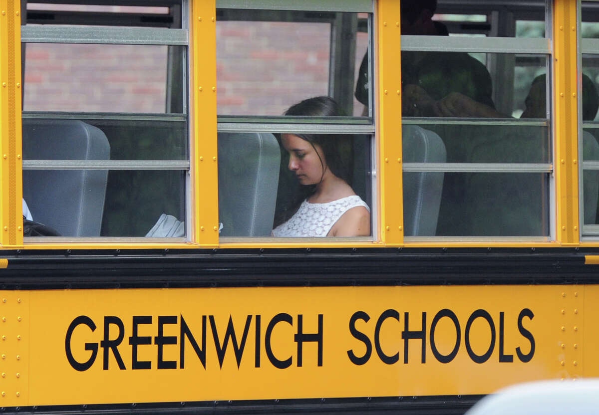 A Greenwich High School student rides the bus during dismissal, Wednesday afternoon, August 28, 2013. A Greenwich High School sophomore, widely reported to have been the victim of bullying, committed suicide after the first day of classes Tuesday. Bartlomiej "Bart" Palosz, 15, shot himself to death Tuesday night at his family's home in Byram, police said.