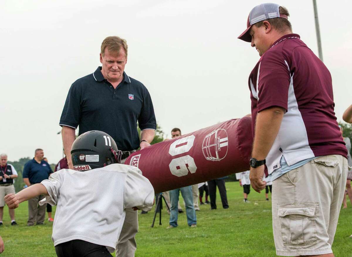 NFL Commissioner Roger Goodell visits a Fairfield Giants Pop Warner football practice at Sullivan Field, Fairfield, CT on Wednesday August 28th, 2013. The commissioner was there to congratulate the Fairfield Giants program for participating in the "Heads Up Football" program that teaches a safer way to play the game. Here Commissioner Goodell helps out the coaches during a drill with the younger players.