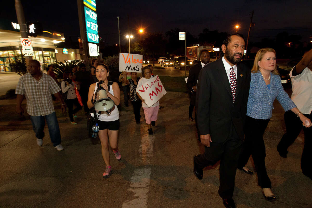 Protestors along with Congressman Al Green and State Senator Sylvia Garcia, right, walk in protest of wages paid to fast food employees, Thursday, Aug. 29, 2013, in Houston. Protestors joined the national movement to try and increase wages to $15 per hour for minimum wage.
