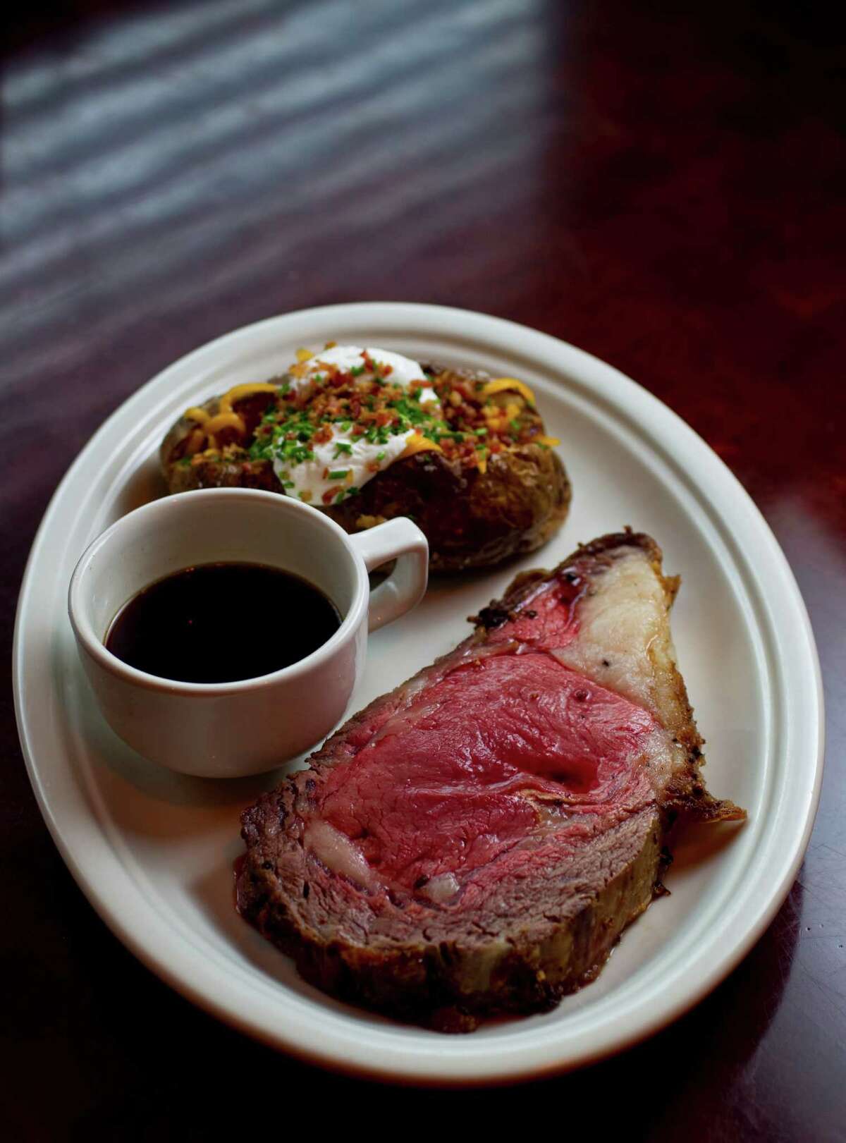 The Laurenzo family, owners of El Tiempo Cantina restaurants and Laurenzo’s on Washington, plan to open a second Laurenzo’s at 1910 Bagby in the former Republic Smokehouse location in Midtown. They expect to open before the Super Bowl. Shown: The Prime Rib with au jus and a loaded baked potato at Laurenzo's, 4412 Washington.