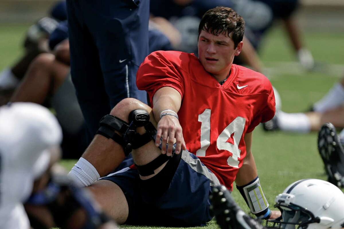 Penn State quarterback Christian Hackenberg (14) stretches during the NCAA college football team's practice in State College, Pa., Thursday, Aug. 8, 2013. Do not hold Penn State coach Bill O'Brien to the timeline that he would settle on a starting quarterback in a couple weeks. (AP Photo/Gene J. Puskar) ORG XMIT: PAGP123