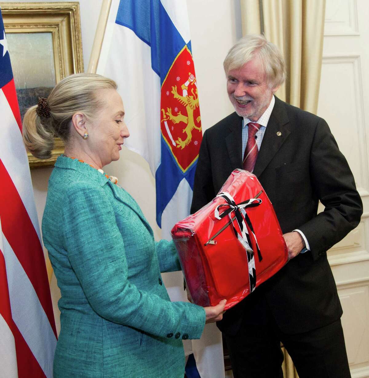 FILE - In this June 27, 2012 file-pool photo, then-Secretary of State Hillary Rodham Clinton receives a gift from Finnish Foreign Minister Erkki Tuomioja at the Government Banquet Hall in Helsinki, Finland. Former Secretary of State Hillary Rodham Clinton has outpaced President Barack Obama when it comes to lavish gifts from foreign leaders. State Department documents released Friday show Clinton got gold jewelry worth a half-million dollars from King Abdullah of Saudi Arabia, while Obamaâs most expensive gift was a $16,500 gold-plated clock from Crown Prince Salman bin Abdulaziz al-Saud, the Saudi defense minister. The gifts were among a bounty of vases, watches, art work and other items given to top U.S. officials in 2012, according to the departmentâs Office of Protocol, which catalogs the gifts and publishes an annual listing. (AP Photo/Haraz N. Ghanbari, Pool)