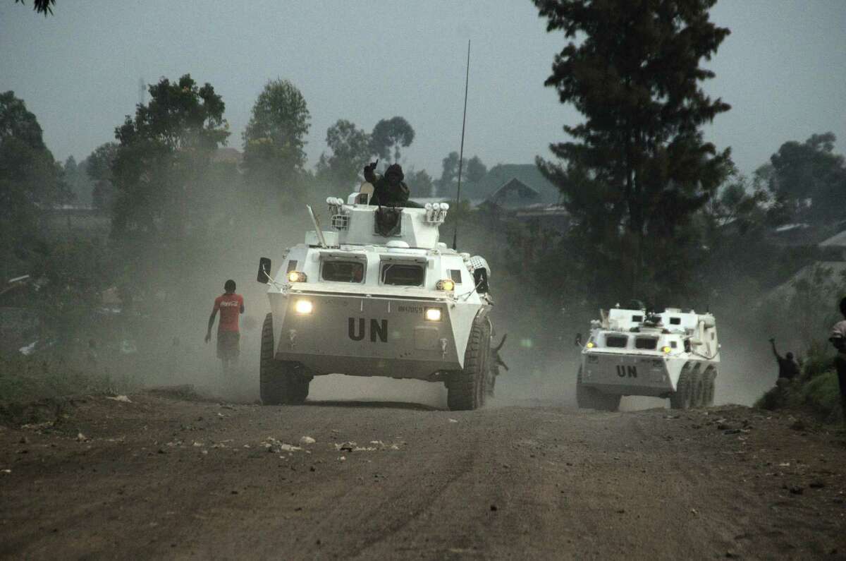 United Nations armored personnel carriers head toward the front drive into Munigi, just north of the provincial capital of Goma in eastern Congo.