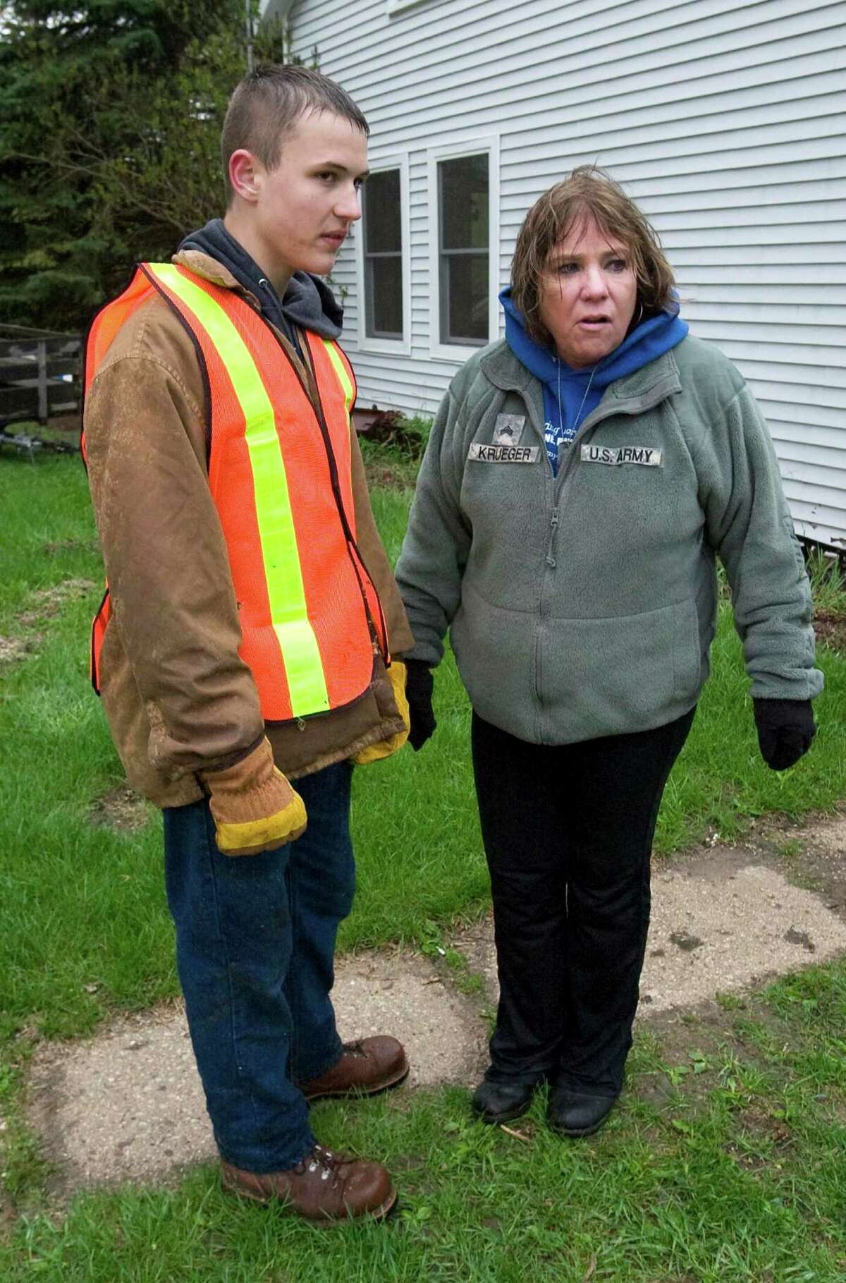 Jeri Krueger, seen here outside her home in Kiel, Wis., with Naval Sea Cadet Tyler Tuttle, lost her daughter, Staff Sgt. Amy Krueger, in the Nov. 5, 2009, attack at Fort Hood. The grieving mother said she shed tears of relief after the man responsible was sentenced to death.