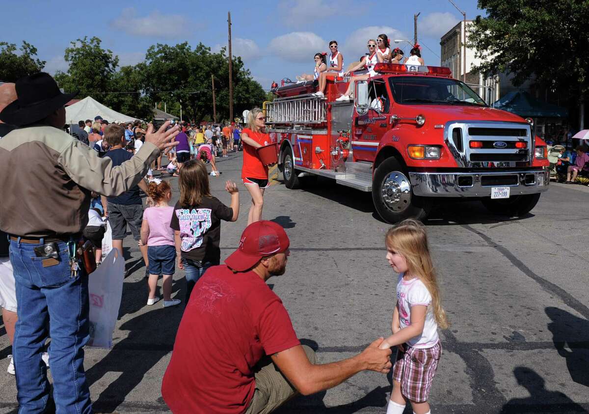 In this Sept. 1, 2012 photo, a volunteer fire department truck turns the corner during the annual Westfest parade in West, Texas. Starting Friday, Aug. 30, 2013, the town will hold the signature celebration of its Czech heritage - the first Westfest since a deadly fertilizer plant explosion tore through the small Central Texas community in April 2013. (AP Photo/Waco Tribune Herald, Rod Aydelotte)