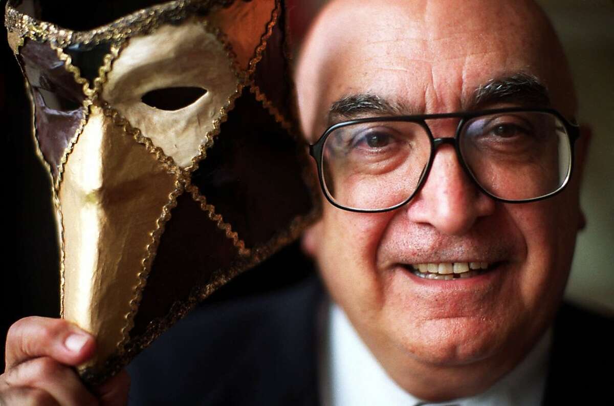 ADVANCE FOR WEEKEND EDITIONS, JULY 6-9--Lotfi Mansouri, general director of the San Francisco Opera, poses with a mask from the 1999 production of "A Masked Ball" by Giuseppe Verdi, in his office at the San Francisco Opera House, June 28, 2000. Mansouri is fond of saying that he saved countless lives over the years by making opera his profession. Now, sadly, at age 71, Mansouri is just one year away from retiring as general director of the opera. (AP Photo/Jakub Mosur)