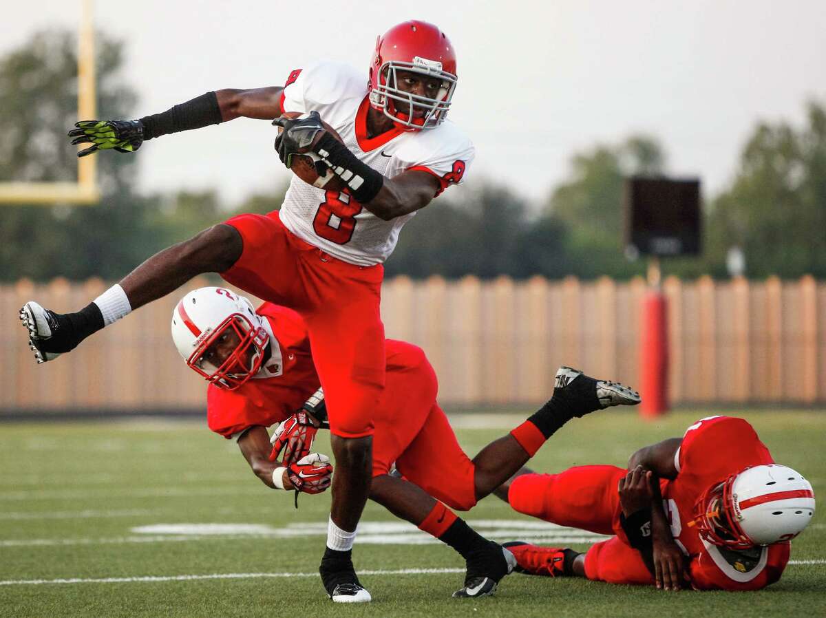 Alief Taylor wide receiver Keenen Brown (8) breaks free from a missed Bellaire tackle following one of his five receptions Friday night at Butler Stadium.