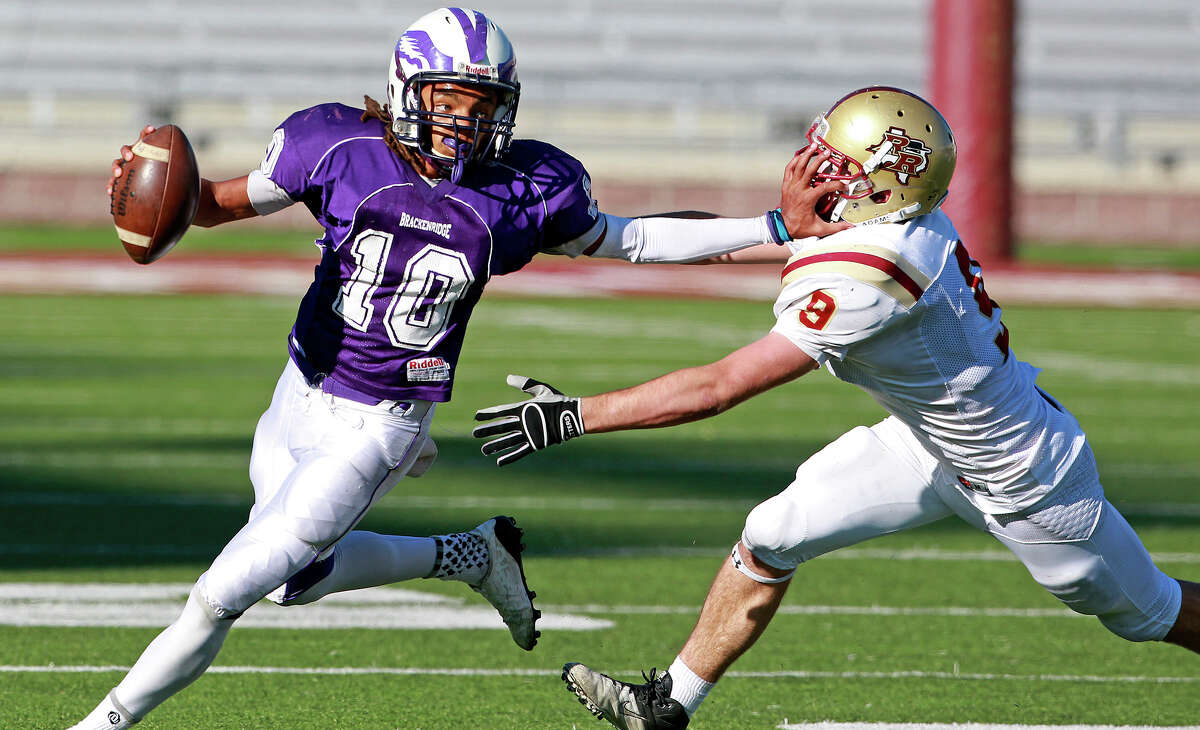 Ramon Richards uses a stiff arm on Travis Leslie to buy some time as he scrambles in the backfield as Brackenridge loses to Leander Rouse 35-14 at Bobcat Stadium in SanMarcos on November 24, 2012.