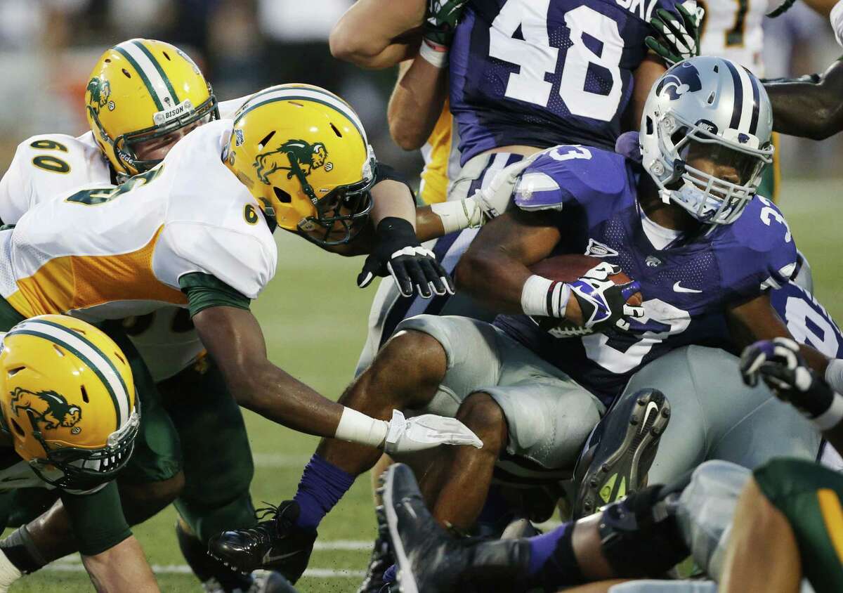 Kansas State running back John Hubert (right) is bottled up by North Dakota State, which held the Wildcats to 48 rushing yards in an upset victory.