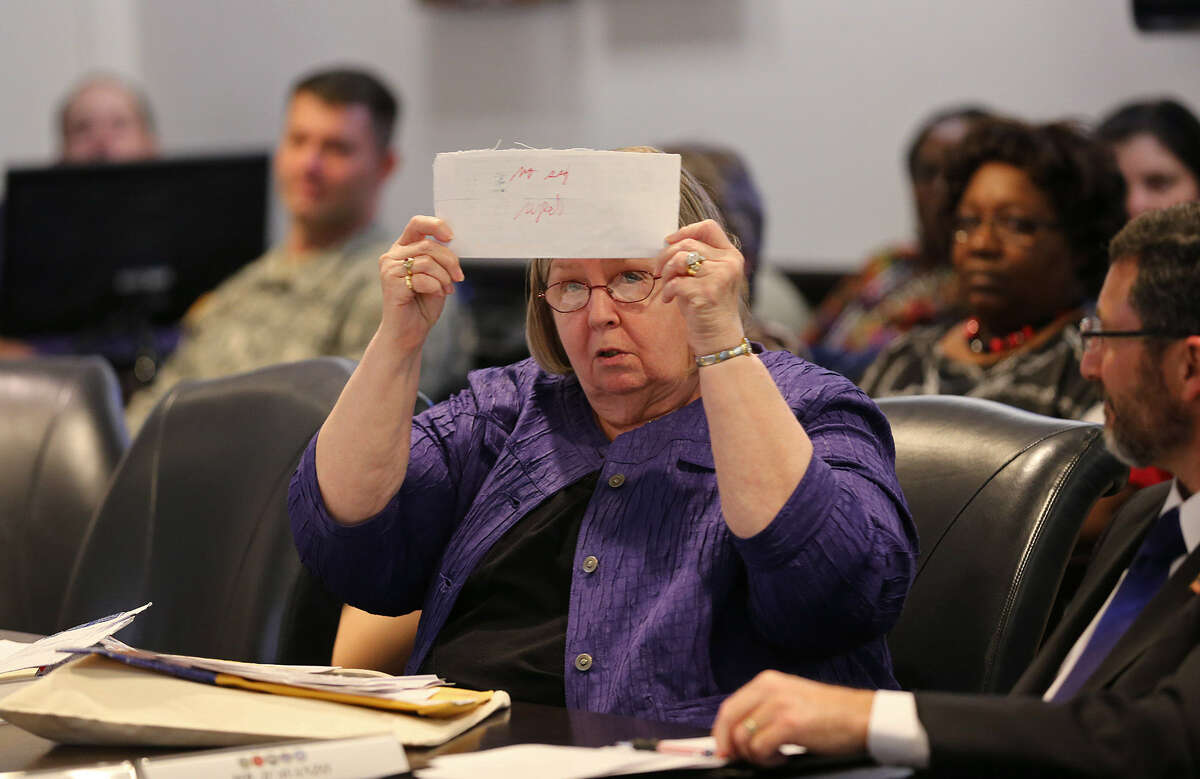 Bexar County Elections Administrator Jacque Callanen shows a rejected military mail-in voter envelope during a February hearing at Joint Base San Antonio-Fort Sam Houston. For the Nov. 5 elections, Callanen's staff and voters will be facing the new voter ID requirements for the first time.