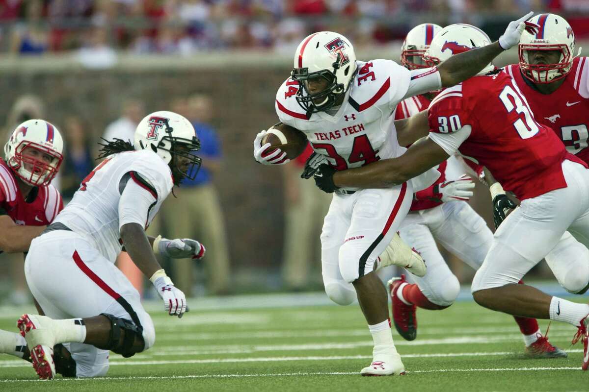 Texas Tech tailback Kenny Williams (34) tries to break free from SMU defenders. Tech won despite its ground game.