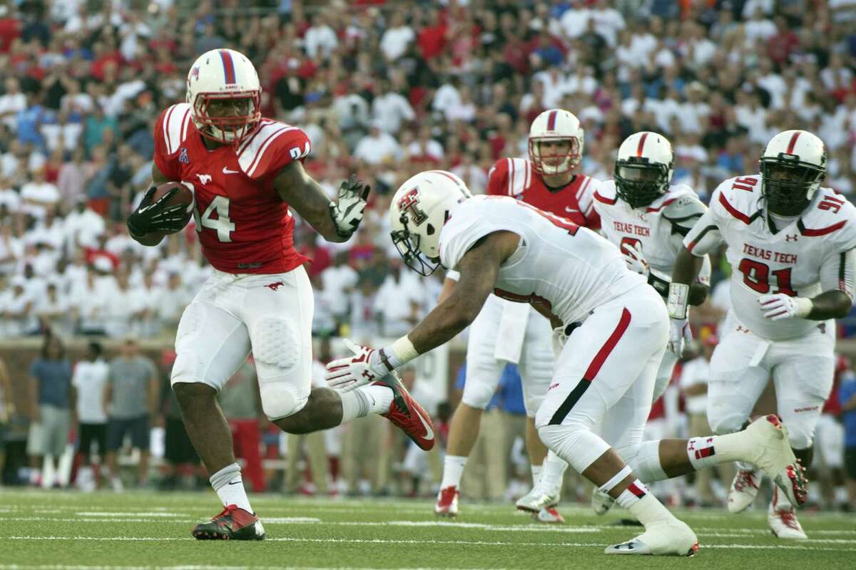DALLAS, TX - AUGUST 30: Traylon Shead #34 of the Southern Methodist Mustangs breaks a tackle against the Texas Tech Red Raiders on August 30, 2013 at Gerald J. Ford Stadium in Dallas, Texas. (Photo by Cooper Neill/Getty Images)