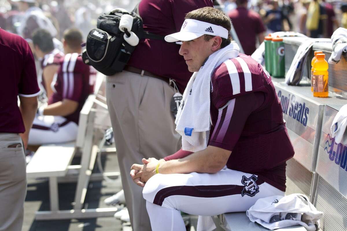 Texas A&M quarterback Johnny Manziel (2) sits on the bench during the first quarter of an NCAA college football game against Rice at Kyle Field Saturday, Aug. 31, 2013, in College Station. ( Brett Coomer / Houston Chronicle )