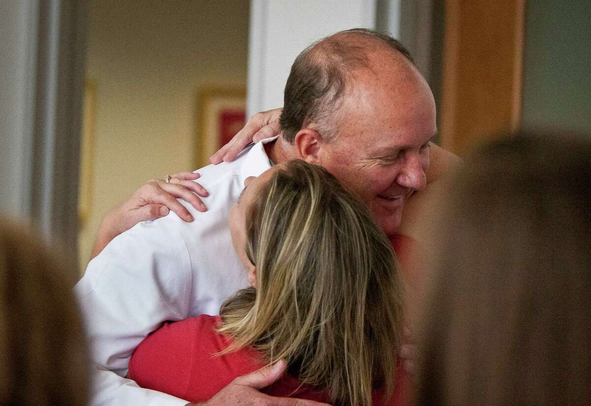 Charles D. Fraser, Jr., M.D. Texas Children's Hospital's surgeon in chief, gets a hug from Denise Dunn, mother of Jacob Dunn, one of Dr. Fraser's patients.