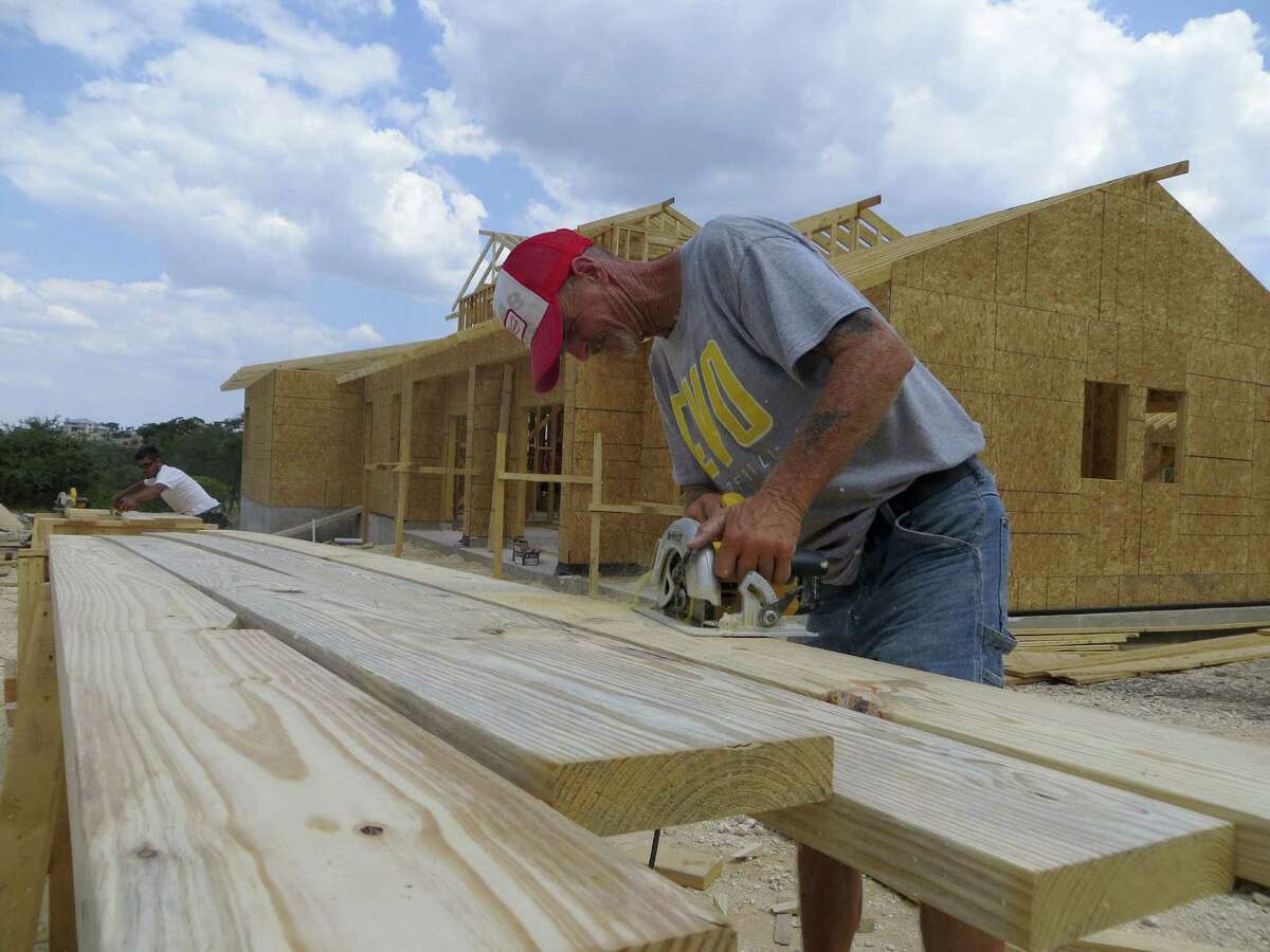 Dave Schulze works on rafters for a home in Cordillera Ranch, an 8,700-acre Kendall County development begun in 1997. Only 20 new homes were built there in 2009, but 35 are now under construction and 38 more are in the design-approval process.