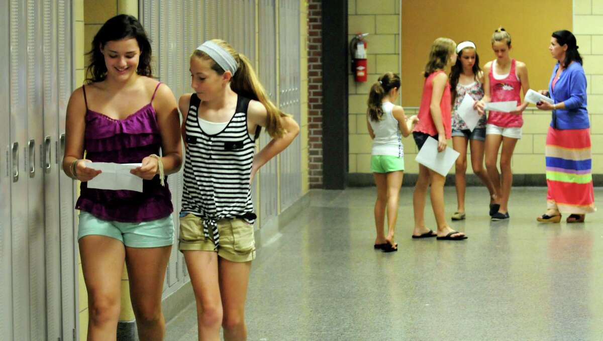 Maeve Sheehan, 13, left, and Callan Powers, 12, center, walk the halls as they locate their eighth grade classes on Wednesday, Aug. 28, 2013, at Bethlehem Middle School in Delmar, N.Y. (Cindy Schultz / Times Union)