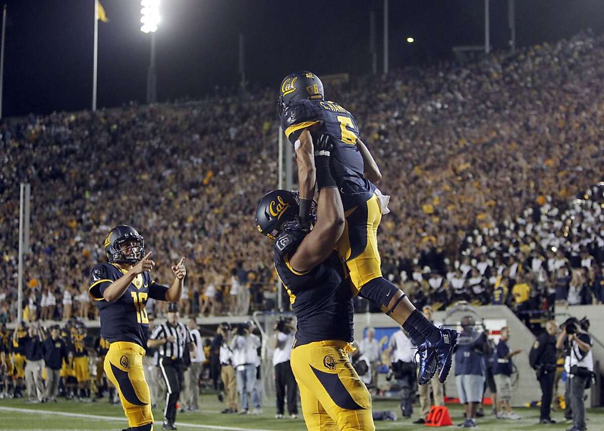 The Bears' Chris Harper, (6) is lifted by teammate Freddie Tagaloa, (78) after his third quarter score as quarterback Jared Goff, (16) looks on,, as the Cal Berkeley Golden Bears take on the Northwestern Wildcats at Memorial stadium in Berkeley , Calif. on Saturday August 31, 2013.