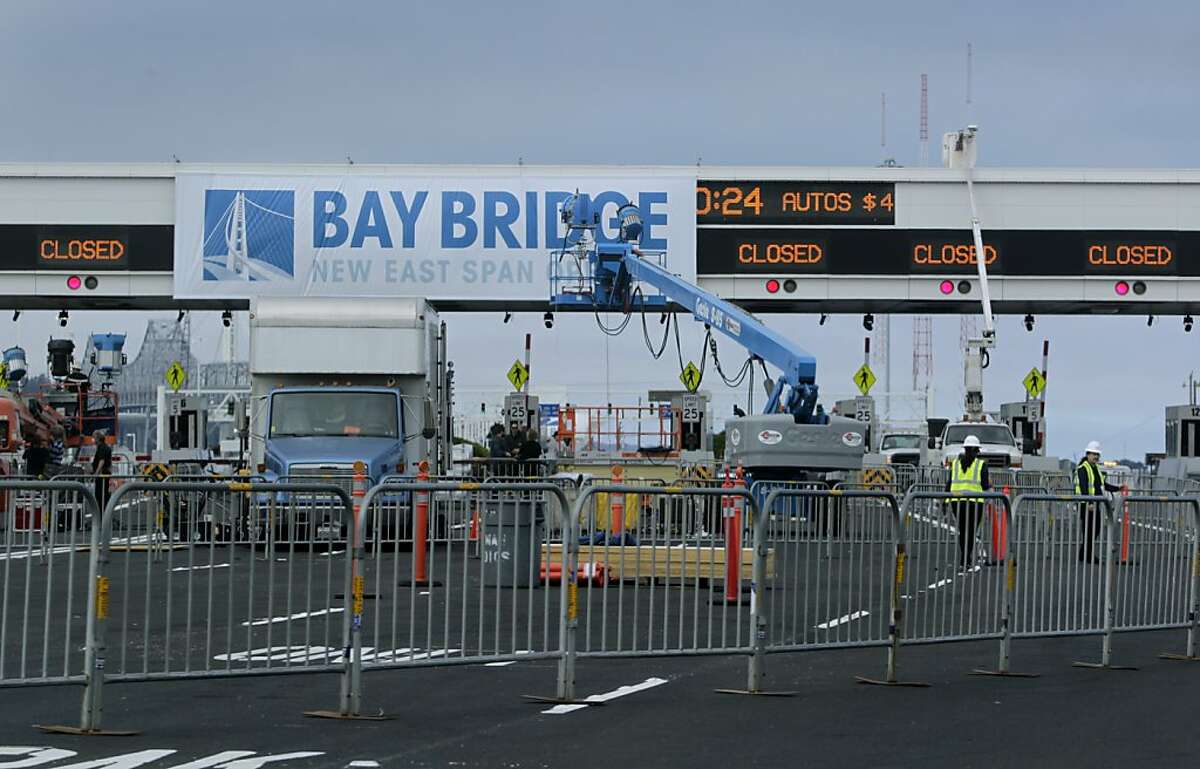 Final preparations are made at the Bay Bridge toll plaza in Oakland, Calif. for the official chain-cutting ceremony on Monday, Sept. 2, 2013 to celebrate the new span's opening. Caltrans expects to open the bridge to commuters on Tuesday at 5 a.m., but may possibly open it several hours earlier if work is completed ahead of schedule.