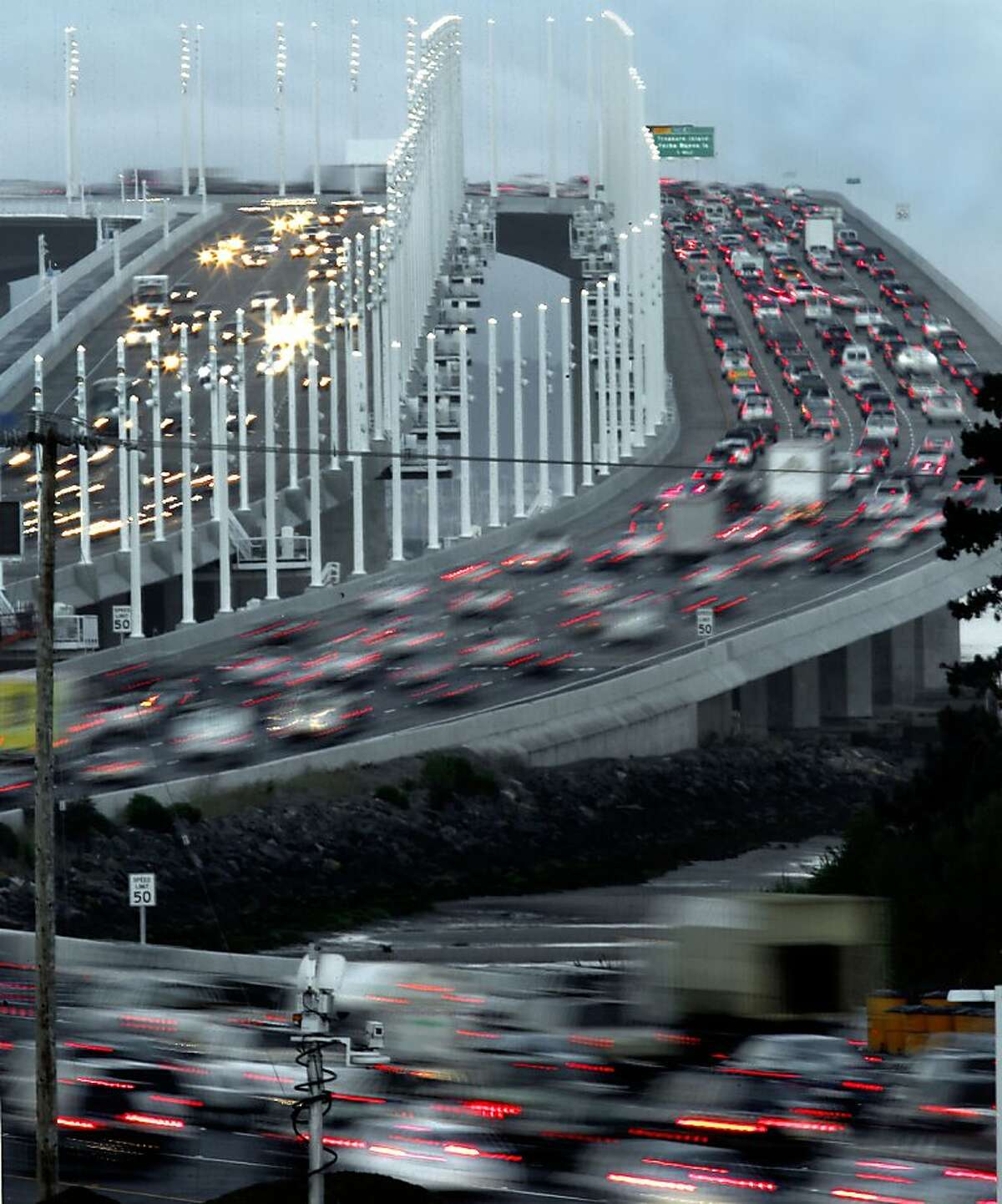 The morning commute in full swing as motorists make their way east and west bound across the roadway, in Oakland, Calif. on Tuesday Sept. 3, 2013, after the new eastern span of the Bay Bridge opened late last evening to traffic.