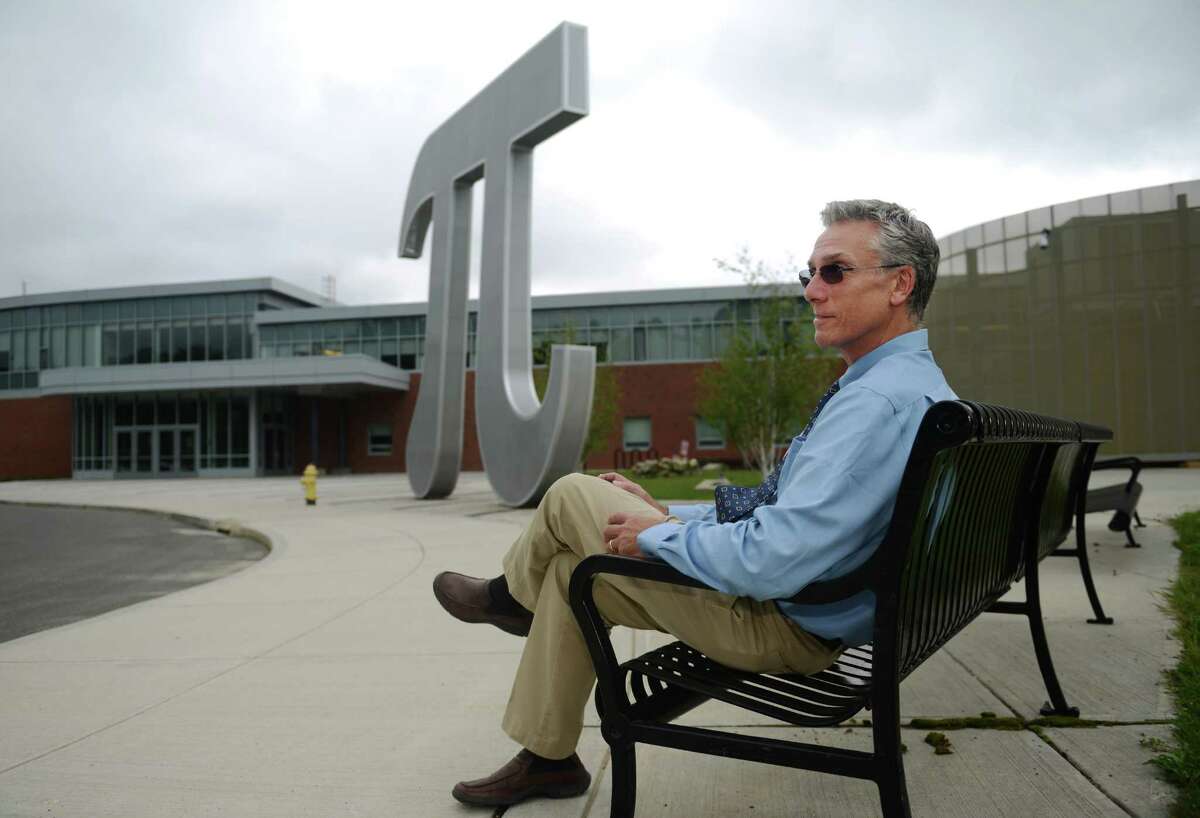 New Abbott Tech. Principal Joseph Tripodi sits outside of the building on his first day working, in Danbury, Conn. on Tuesday, Sept. 3, 2013. Tripodi is replacing former principal Portia Bonner, who was appointed as superintendent of East Haven School District in July.