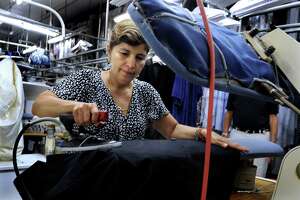 Karin Valez of Danbury, Conn., is a garment finisher at Ship Shape Cleaners in Brookfield, Conn., Tuesday, Sept. 2, 2013.