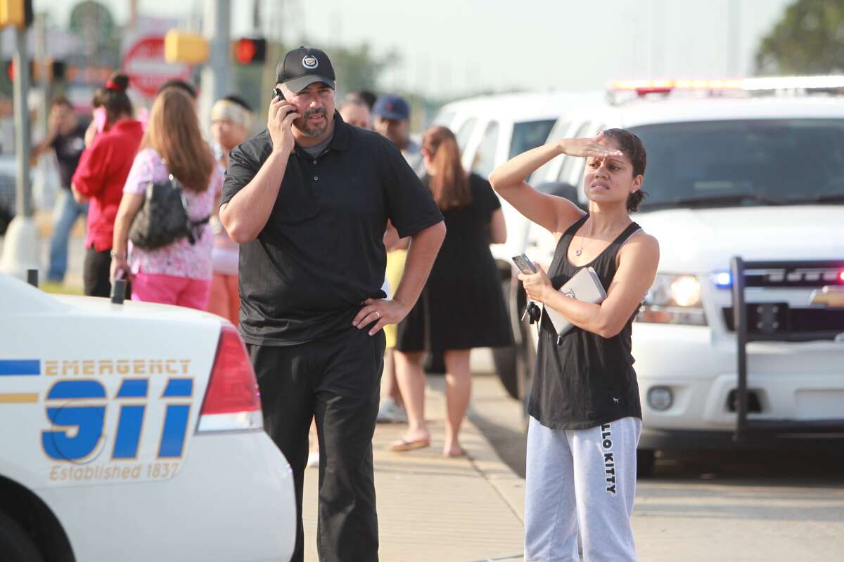 Concerned parents wait outside while police investigate a stabbing at Spring High School on Sept. 4.