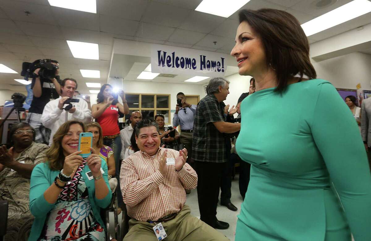 Gloria Estefan enters the library at Winston Elementary School to reunite with her first-grade teacher, Dorothy Collins, on Aug. 30. The music superstar credits Collins with teaching her English.