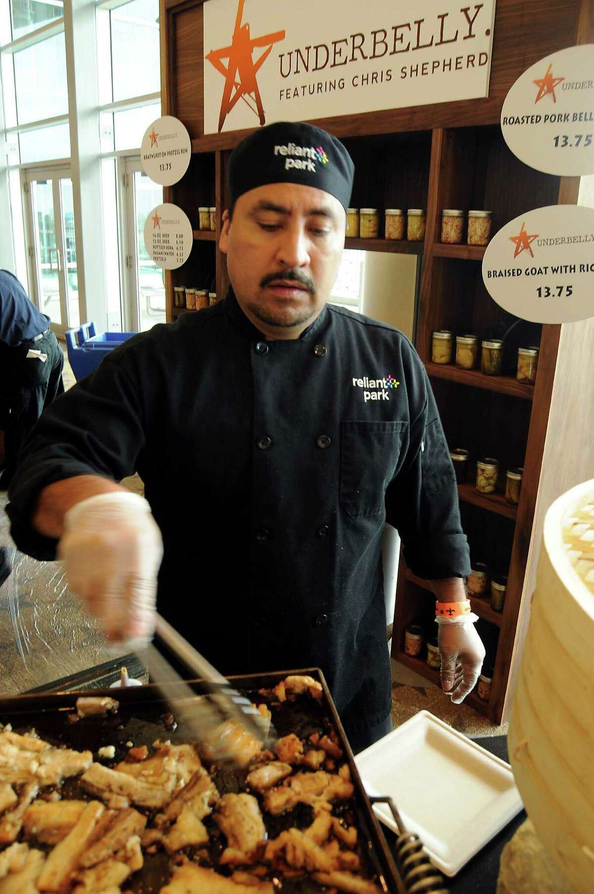 Noe Sotlo cooks pork at the Underbelly concession at Reliant Stadium.