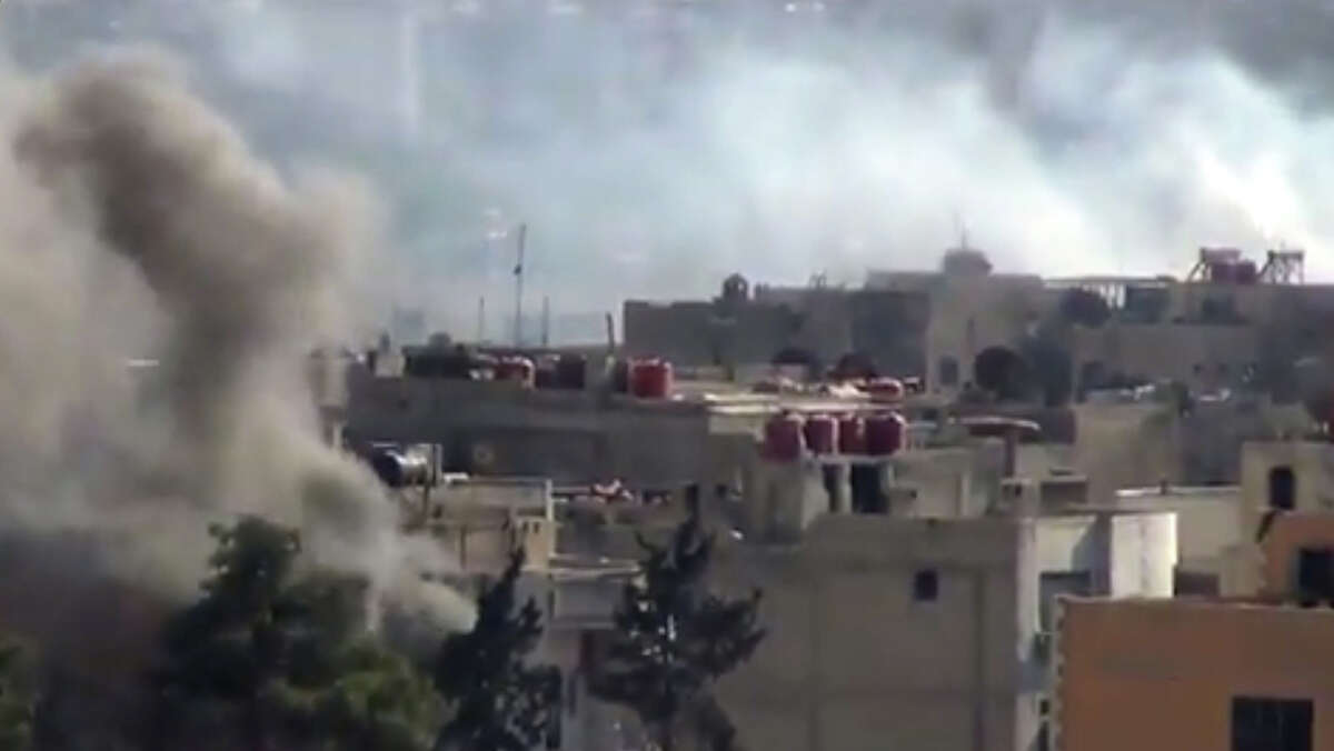 In this image taken from video obtained from the Shaam News Network, which has been authenticated based on its contents and other AP reporting, smoke rises from buildings due to heavy clashes between Free Syrian army fighters and government forces in Daraya, a suburb of Damascus, Syria, Wednesday, Sept. 4, 2013. (AP Photo/Shaam News Network via AP video)